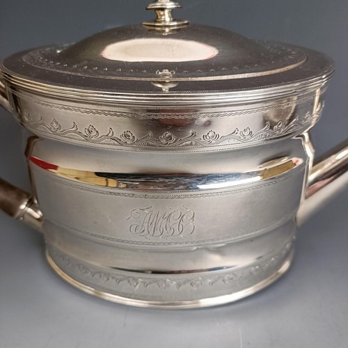 395 - A late 18th century oval silver teapot and teapot stand, initialled and with engraved decoration, Lo... 