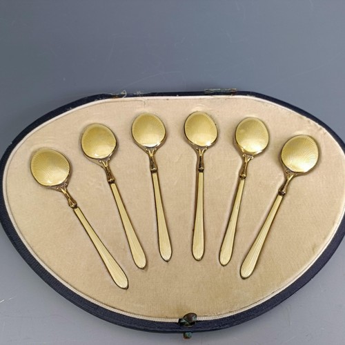 396 - A set of six silver gilt and yellow enamel teaspoons, boxed