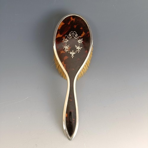 398 - A silver and tortoiseshell mounted hairbrush