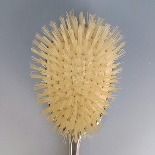 399 - A hairbrush, with floral enamel decoration