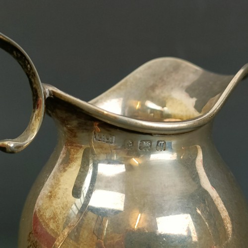 400 - A George V silver cream jug, 2.1 ozt, and a pierced silver vase, almost split into two pieces, base ... 