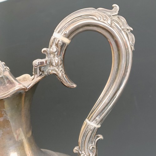 402 - A Victorian silver wine ewer, decorated flowers, with ivory spacers, Birmingham 1856, all in, 33.7 o... 