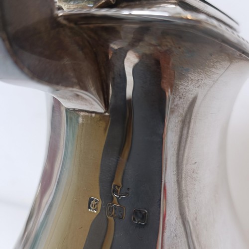 371 - A George V silver hot water jug, with an ebonised handle, Birmingham 1919, all in 18.8 ozt