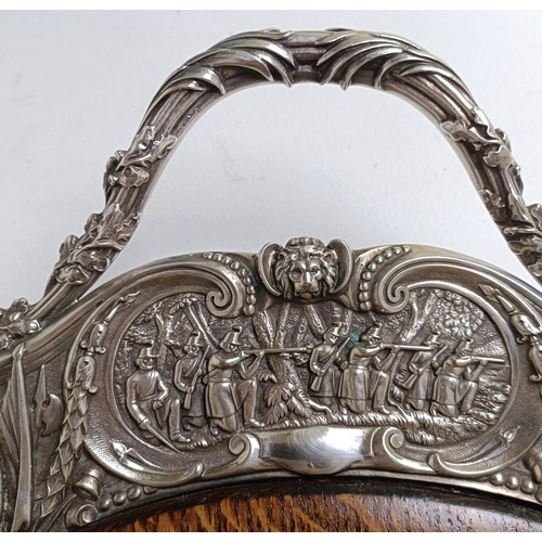 422 - An impressive Victorian silver plated and oak tray, the border decorated with battle scenes, the cen... 