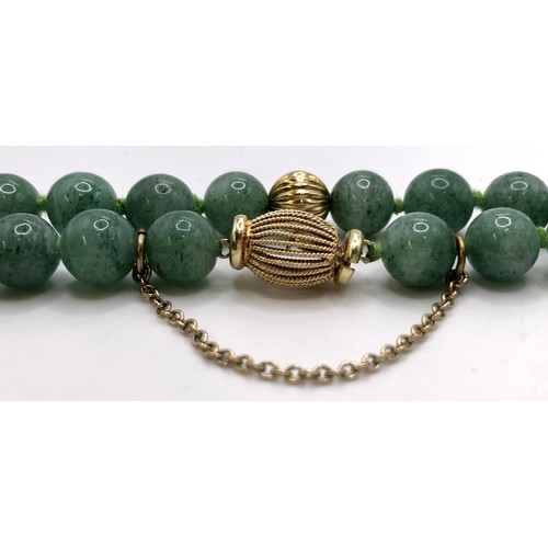 689 - A green bead necklace, with a 14ct gold clasp