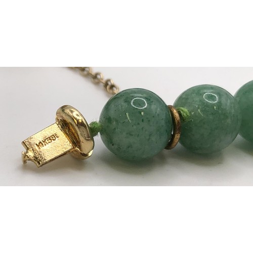 689 - A green bead necklace, with a 14ct gold clasp