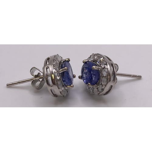 694 - A pair of 18ct white gold, tanzanite and diamond earrings