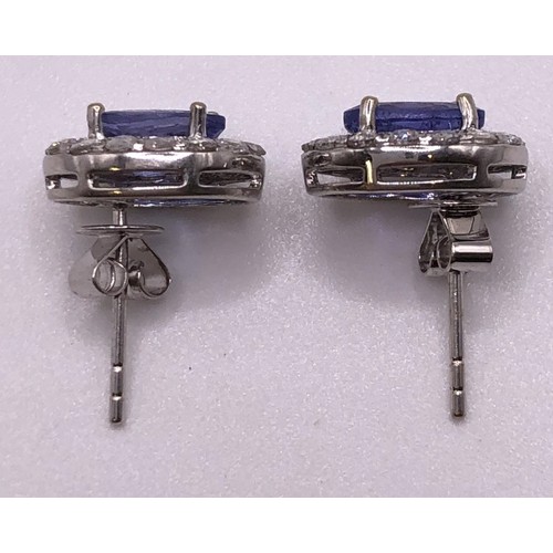 694 - A pair of 18ct white gold, tanzanite and diamond earrings