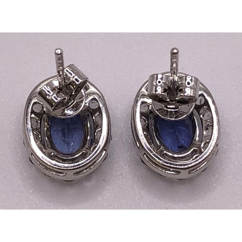 694 - A pair of 18ct white gold, tanzanite and diamond earrings