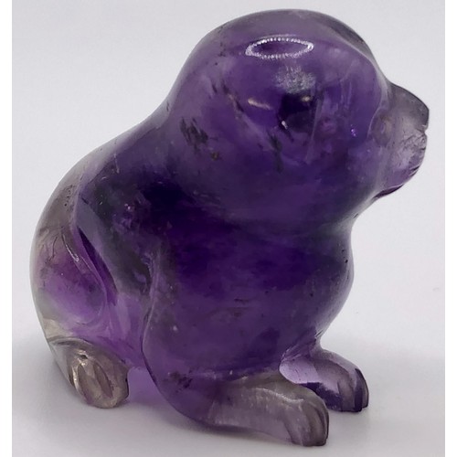 696 - A purple stone carving of a puppy, 4 cm wide