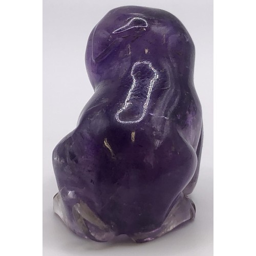 696 - A purple stone carving of a puppy, 4 cm wide