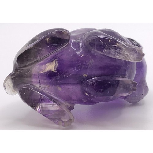 696 - A purple stone carving of a puppy, 4 cm wide