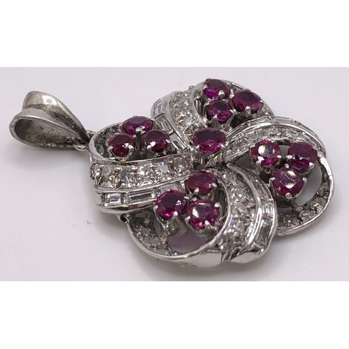 698 - A ruby and diamond floral pendant