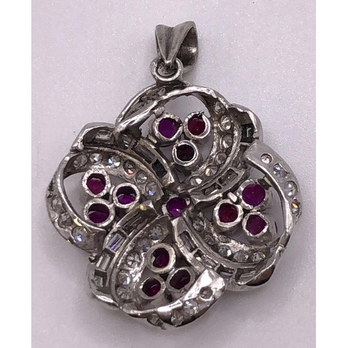 698 - A ruby and diamond floral pendant