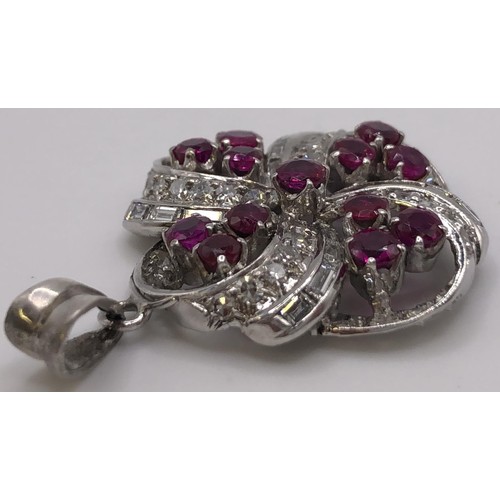 698 - A ruby and diamond floral pendant