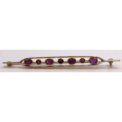 699 - A 15ct gold and ruby bar brooch, in a vintage jewellery box