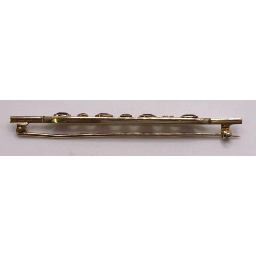 699 - A 15ct gold and ruby bar brooch, in a vintage jewellery box