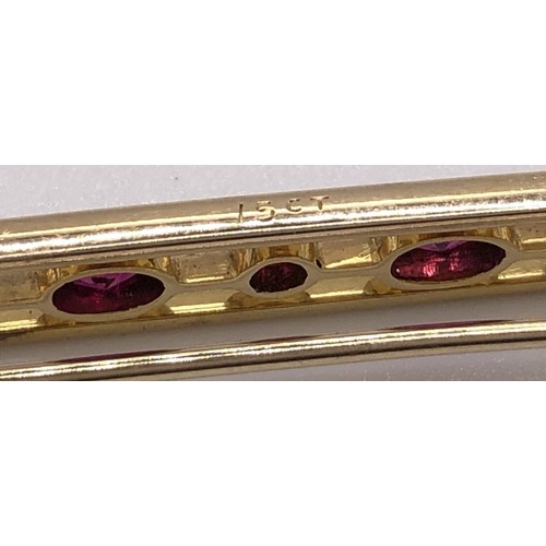 699 - A 15ct gold and ruby bar brooch, in a vintage jewellery box