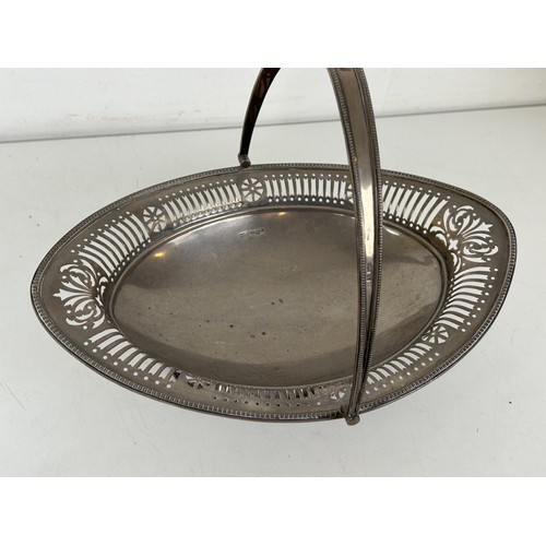 364 - A George III style pierced swing handle basket, of navette form, Sheffield 1926, 15.5 ozt, 28.5 cm w... 