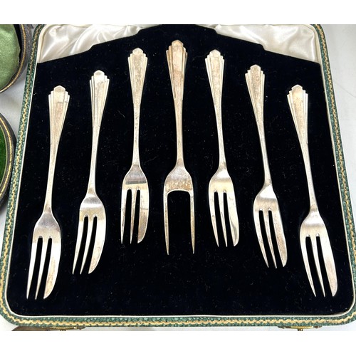 434 - A set of six Art Deco silver cake forks, cased, a fork, spoon and napkin ring, cased, a set of six A... 