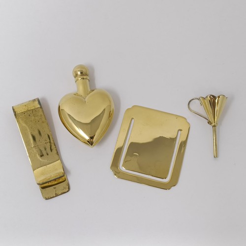 317 - A silver gilt money clip, another, a gold plated miniature funnel, and a gold plated heart shaped pe... 