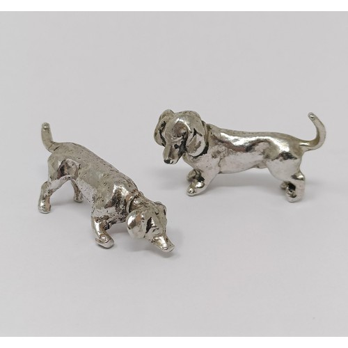 345 - A silver coloured metal figure of a horse, 4 cm wide, a pair of silver coloured metal figures of Dac... 