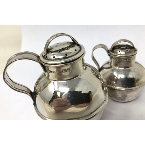 112 - A silver pepperette, in the form of a Guernsey jug, Birmingham 1938, 6.5 cm high, and another, 5 cm ... 