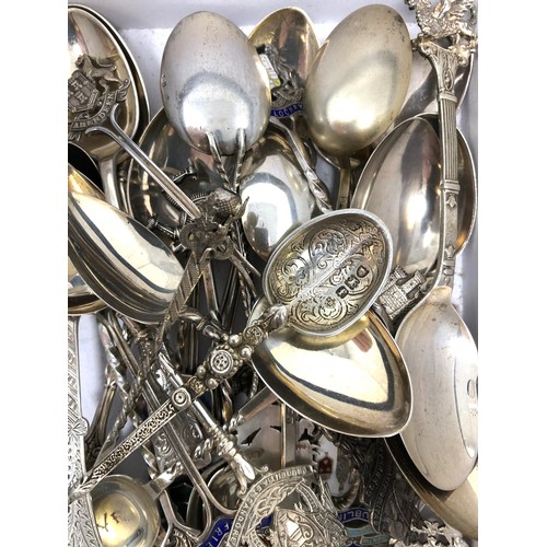 87 - Assorted silver coloured metal and other travel/commemorative spoons, some with enamel decoration