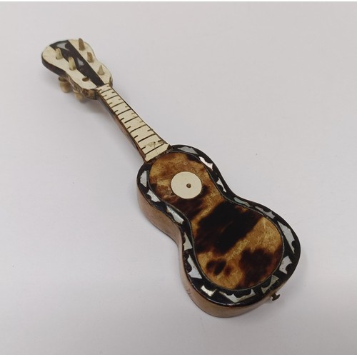 750 - A tortoiseshell oval box, a novelty miniature guitar and other items (box)