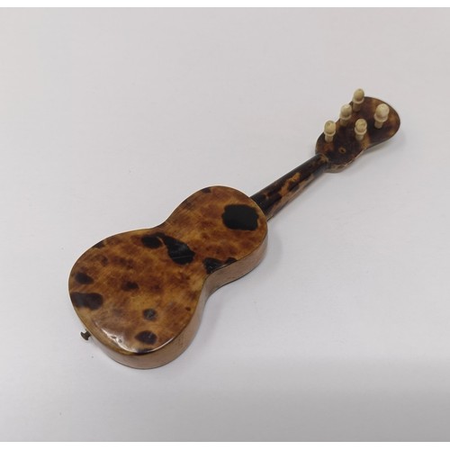 750 - A tortoiseshell oval box, a novelty miniature guitar and other items (box)