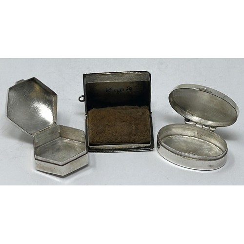 293 - A silver oval pill box, an octagonal pill box, and a vinaigrette in the form of a book (3)