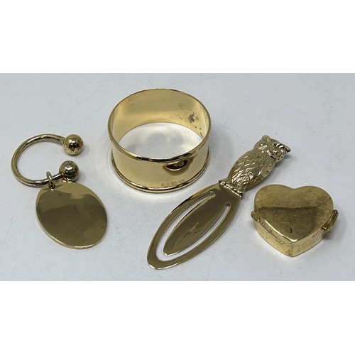 323 - A silver gilt novelty page mark, in the form of an owl, a napkin ring, a gold plated dog tag, and a ... 