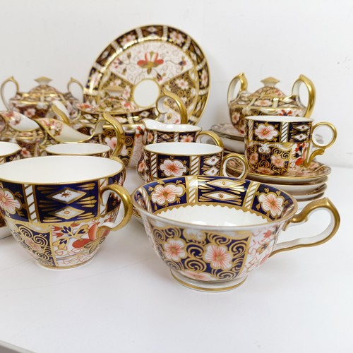 1033 - A Royal Crown Derby Imari pattern part tea service, comprising a teapot, two tureens, two cream jugs... 