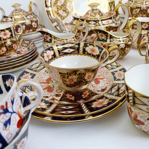 1033 - A Royal Crown Derby Imari pattern part tea service, comprising a teapot, two tureens, two cream jugs... 