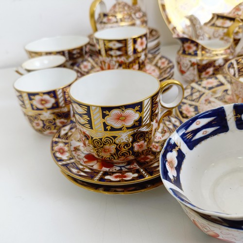 1033 - A Royal Crown Derby Imari pattern part tea service, comprising a teapot, two tureens, two cream jugs... 