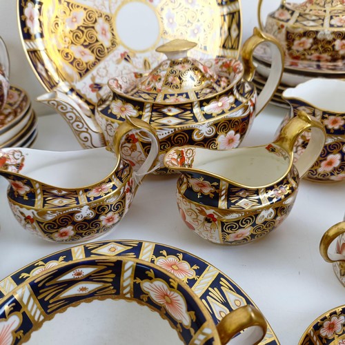 1033 - A Royal Crown Derby Imari pattern part tea service, comprising a teapot, two tureens, two cream jugs... 