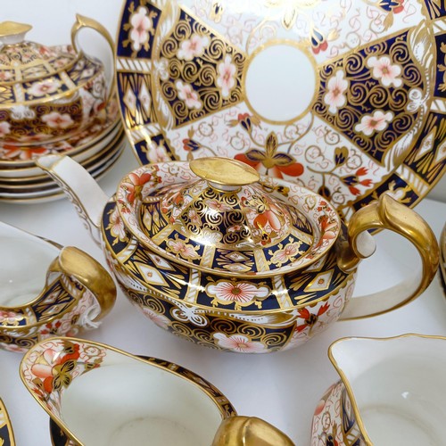 1033 - A Royal Crown Derby Imari pattern part tea service, comprising a teapot, two tureens, two cream jugs... 