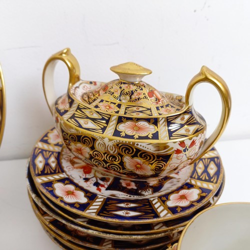 1033 - A Royal Crown Derby Imari pattern part tea service, comprising a teapot, two tureens, two cream jugs... 