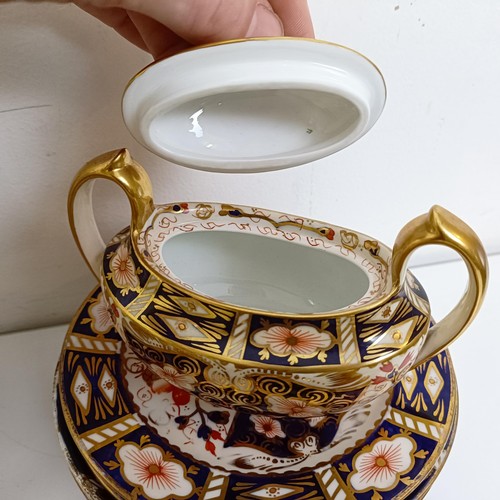 1033 - A Royal Crown Derby Imari pattern part tea service, comprising a teapot, two tureens, two cream jugs... 