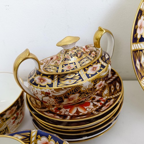 1033 - A Royal Crown Derby Imari pattern part tea service, comprising a teapot, two tureens, two cream jugs... 