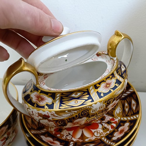 1033 - A Royal Crown Derby Imari pattern part tea service, comprising a teapot, two tureens, two cream jugs... 