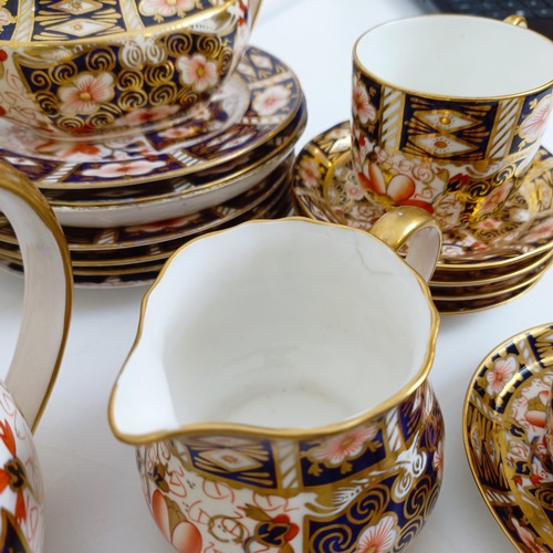 1033 - A Royal Crown Derby Imari pattern part tea service, comprising a teapot, two tureens, two cream jugs... 