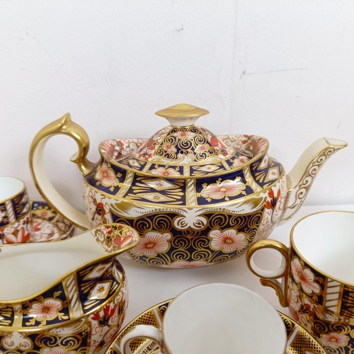 1034 - A Royal Crown Derby Imari pattern part tea service, comprising a teapot, a cream jug, two dishes, an... 