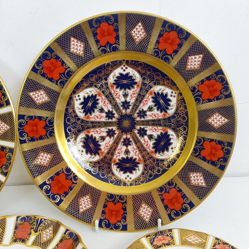 1041 - A pair of Royal Crown Derby Old Imari pattern plates, 27 cm, and another, 21.5 cm, two saucers, two ... 