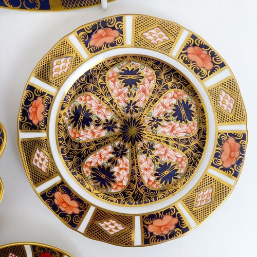 1041 - A pair of Royal Crown Derby Old Imari pattern plates, 27 cm, and another, 21.5 cm, two saucers, two ... 