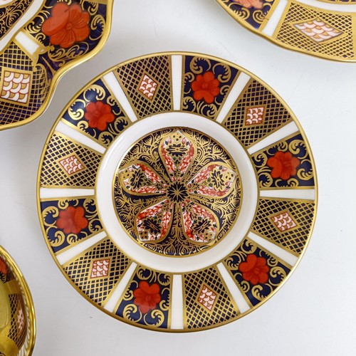 1041 - A pair of Royal Crown Derby Old Imari pattern plates, 27 cm, and another, 21.5 cm, two saucers, two ... 