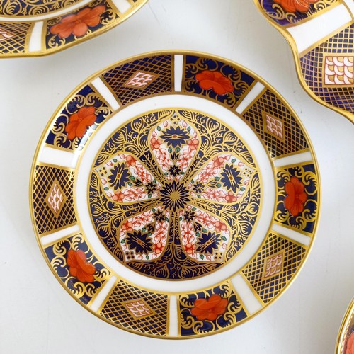 1041 - A pair of Royal Crown Derby Old Imari pattern plates, 27 cm, and another, 21.5 cm, two saucers, two ... 