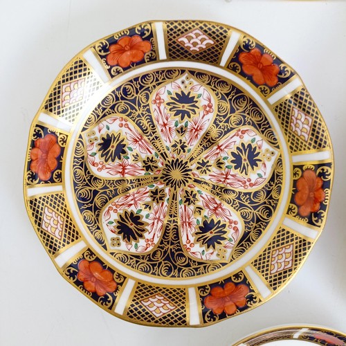 1041 - A pair of Royal Crown Derby Old Imari pattern plates, 27 cm, and another, 21.5 cm, two saucers, two ... 