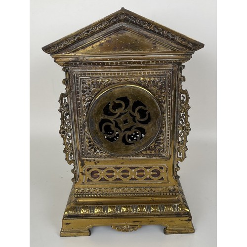 1062 - A mantel clock, the brass dial fitted an eight day movement, striking on a chime, in a brass case, d... 