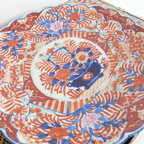 1068 - A Japanese Imari plate, 40 cm diameter, and a silk rug, 64 cm x 46 cm (2)